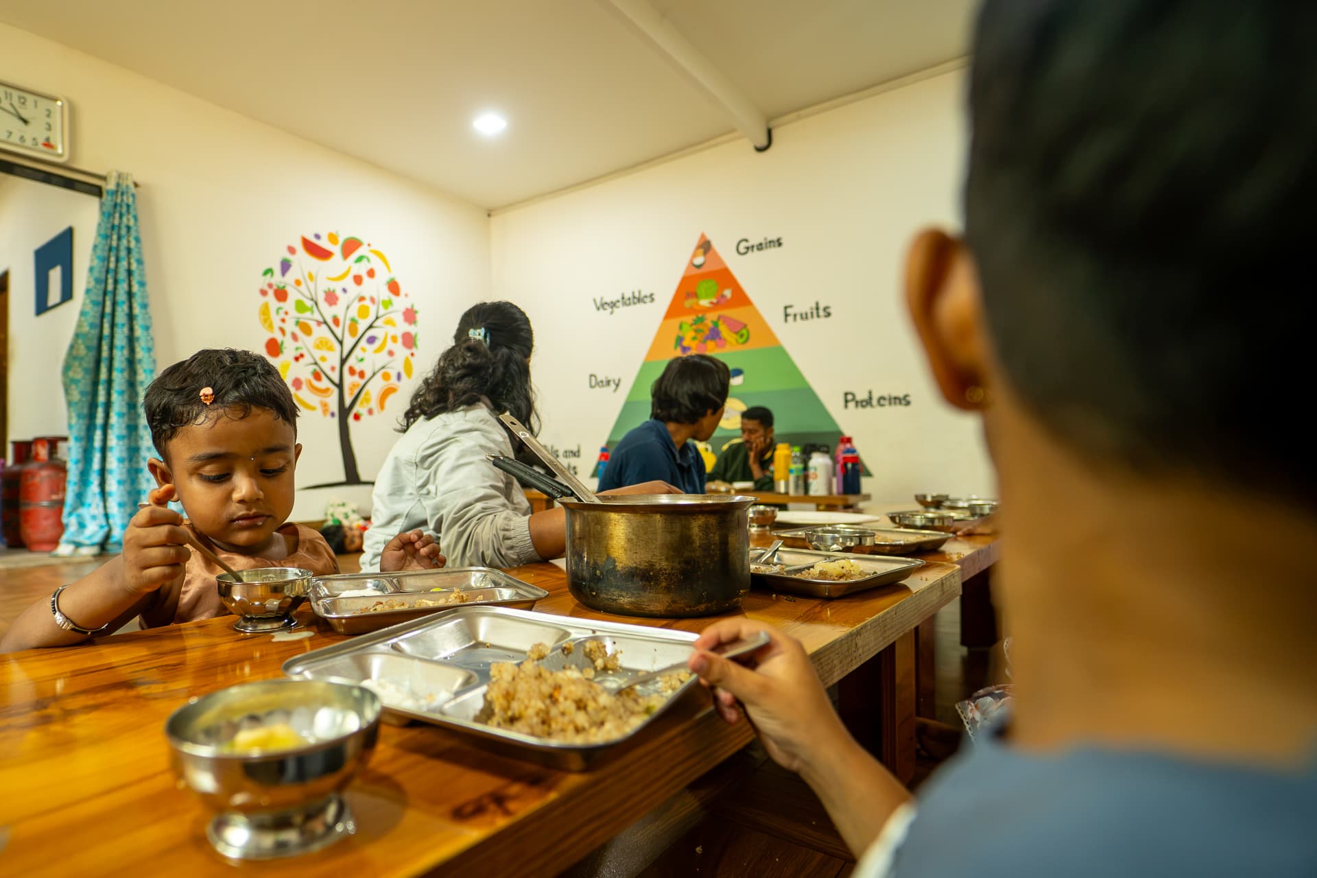 Children seated at desks during a meal